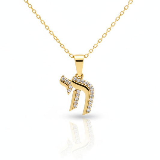 Elegant Chai symbol necklace in gold-tone, pave-set with diamond-like gems, symbolizing life, blessings, and happiness.