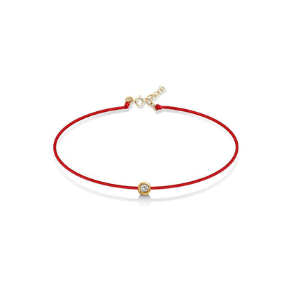Red string bracelet with bezel-set diamond in 14k gold by Alef Bet