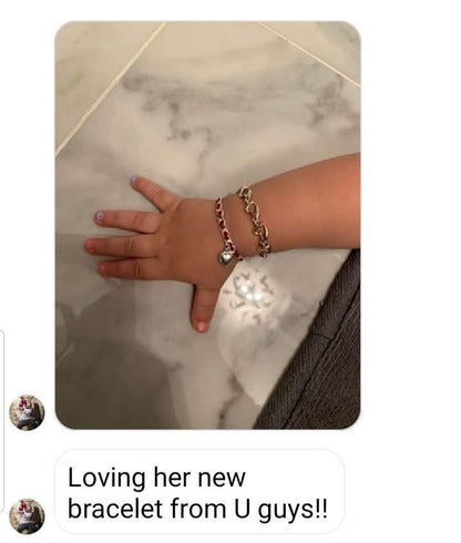 A red string Kaballah love bracelet featuring a sterling silver heart pendant, symbolizing love, protection, and good fortune.