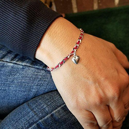 A red string Kaballah love bracelet featuring a sterling silver heart pendant, symbolizing love, protection, and good fortune.