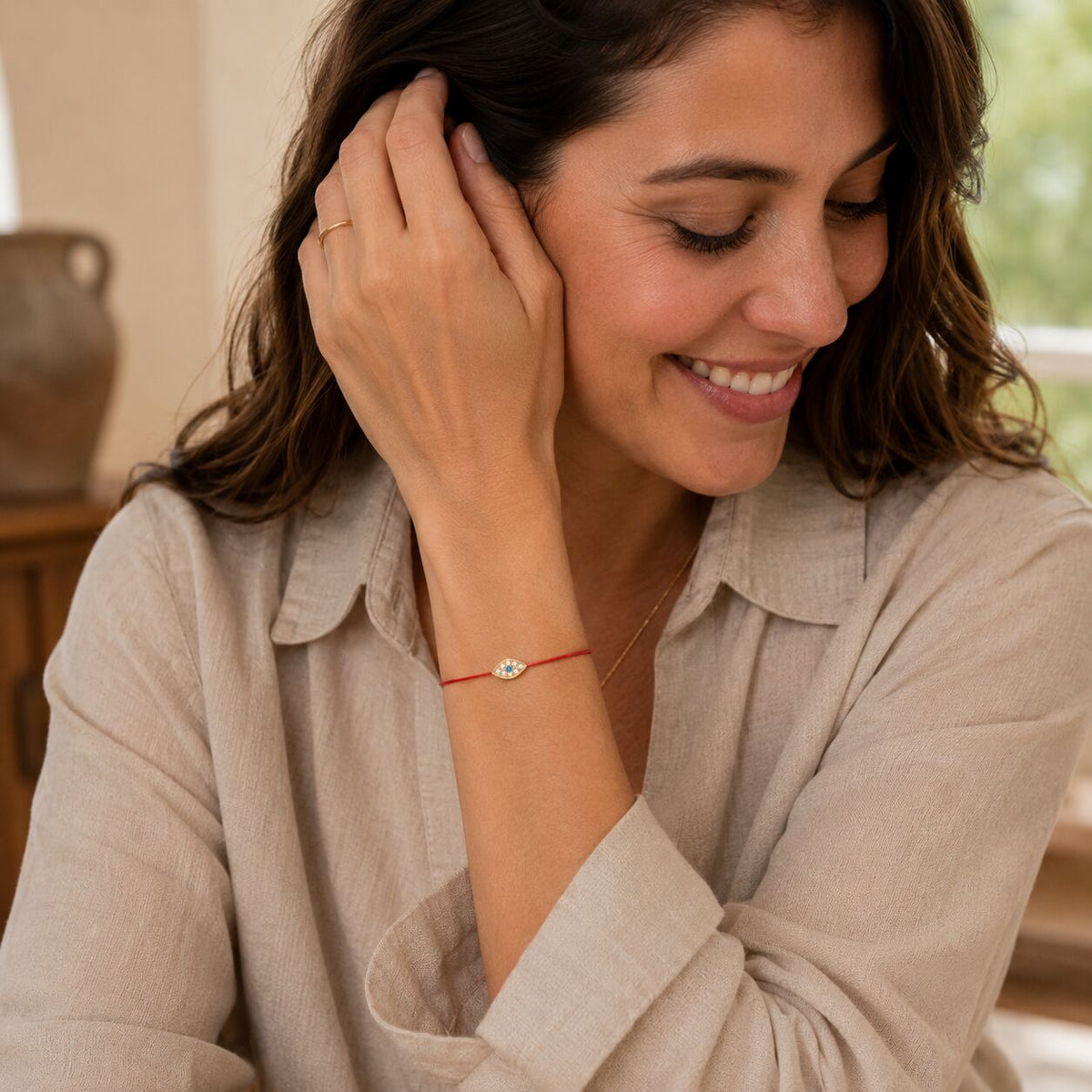 Red string of fate bracelet with adjustable knot closure and evil eye charm by Alef Bet