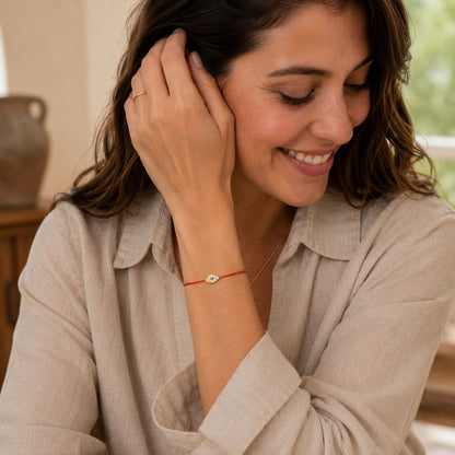 Red string of fate bracelet with adjustable knot closure and evil eye charm by Alef Bet