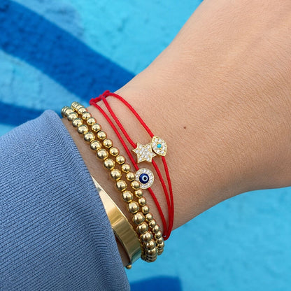 Evil eye bracelet in red cord with protective enamel eye bead by Alef Bet