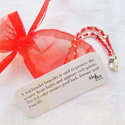 Beautiful sterling silver hamsa charm bracelet on a red string, symbolizing protection and good wishes, perfect for everyday wear.