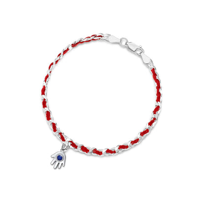 A handcrafted sterling silver hamsa charm bracelet with red string, symbolizing protection and good wishes, gift wrapped with a description card.