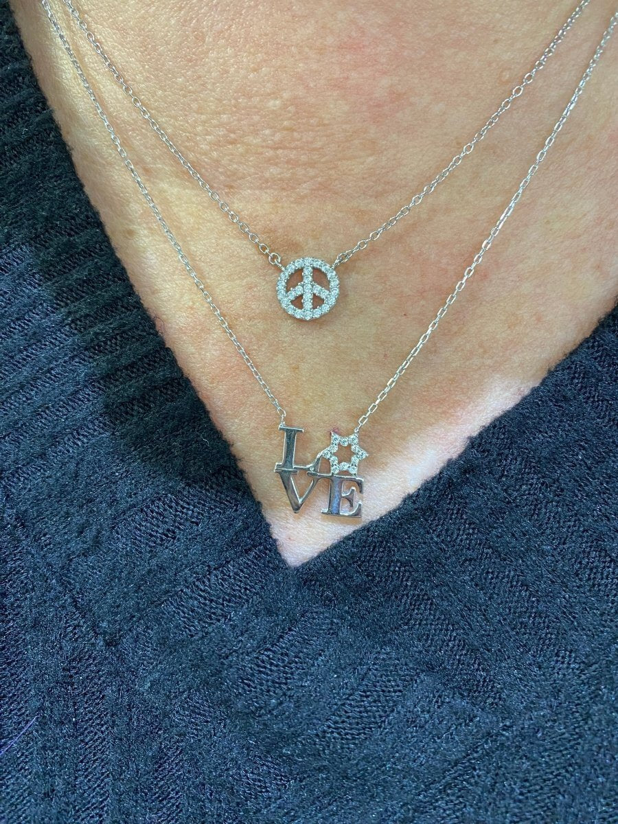 A stunning love letter necklace featuring the letters L V E, with a sparkling Star of David as the O, crafted in sterling silver.