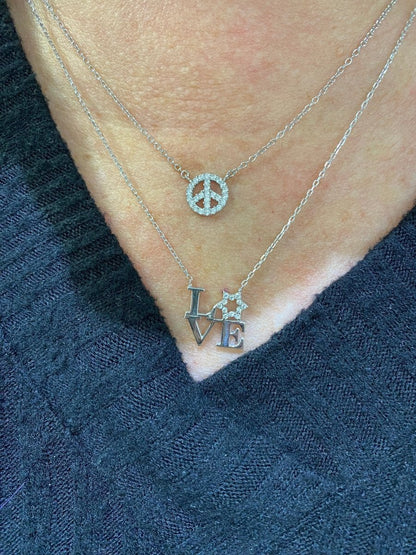 A stunning love letter necklace featuring the letters L V E, with a sparkling Star of David as the O, crafted in sterling silver.
