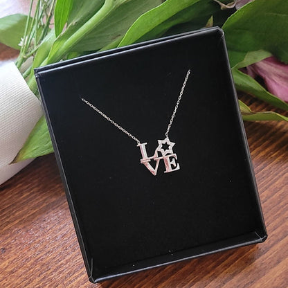 A stunning love letter necklace featuring a sparkling Star of David, crafted from sterling silver with adjustable chain and cubic zirconia.