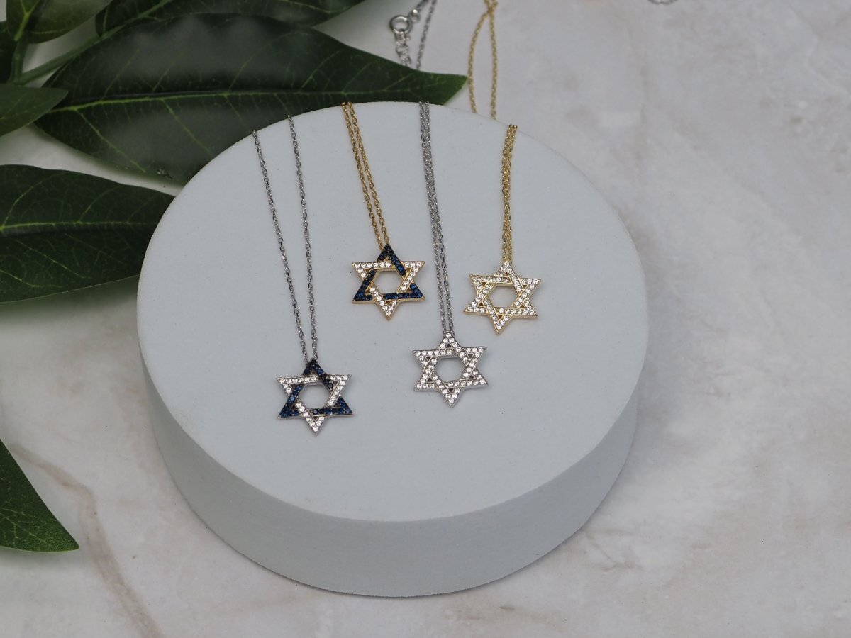 Gold plated Star of David necklace with cubic zircon gemstones, 5/8" pendant, adjustable 16" + 2" chain; a timeless symbol of faith.