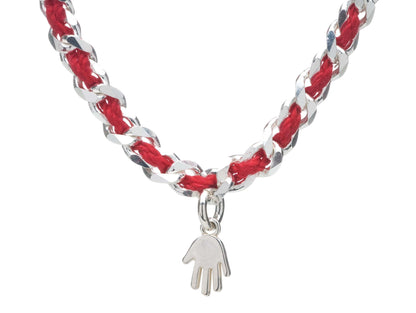 Sterling silver hamsa charm bracelet with a red string, symbolizing protection and good wishes; available in three sizes.