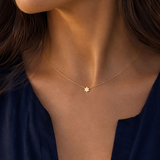 Petite star necklace in 14k yellow gold with high-polish finish by Alef Bet