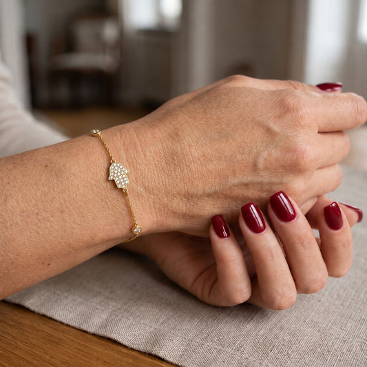 Hamsa bracelet in 14k gold with 0.12 ct pave diamonds and adjustable sizing by Alef Bet