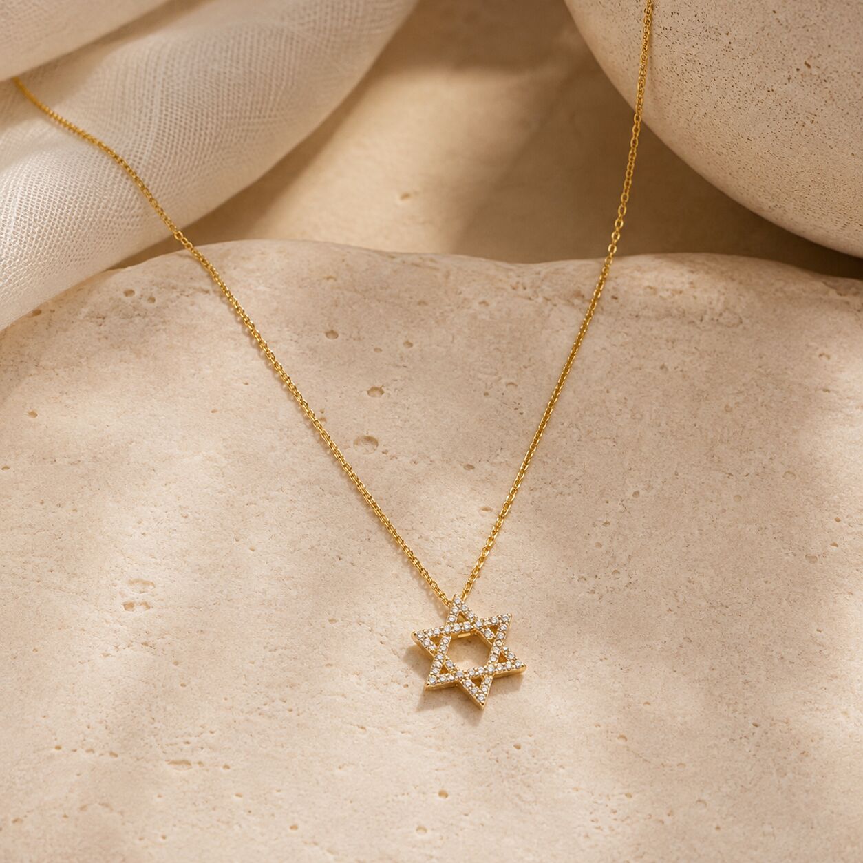 Star necklace in yellow gold with diamond embellishments by Alef Bet