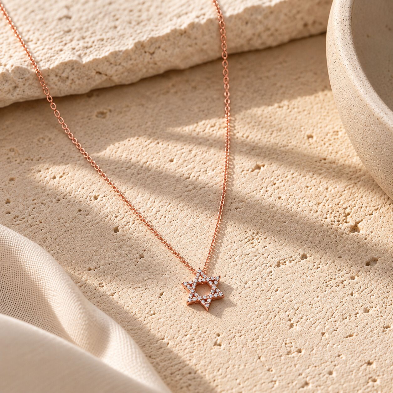 Gold star necklace featuring diamond-studded design by Alef Bet