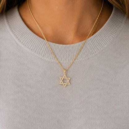 star pendant with diamonds on woman
