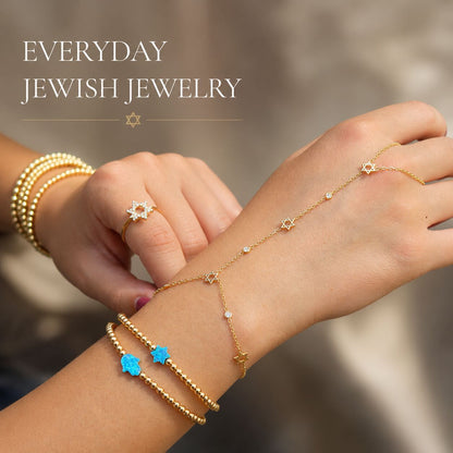 Gold Star of David hand chain bracelet featuring bezel-set colored stones detail view by Alef Bet