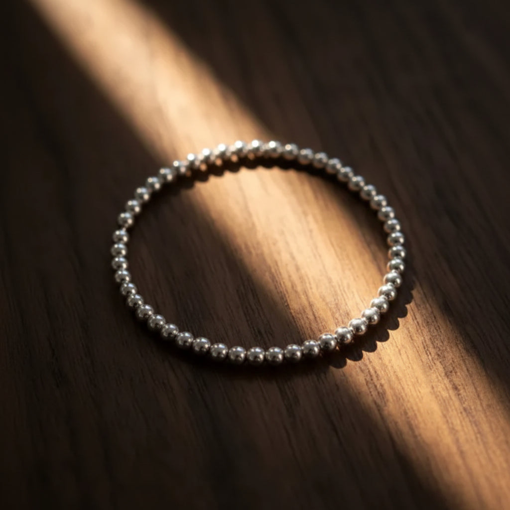 Silver beaded bracelet with 3mm sphere links and satin-finished metal by Alef Bet