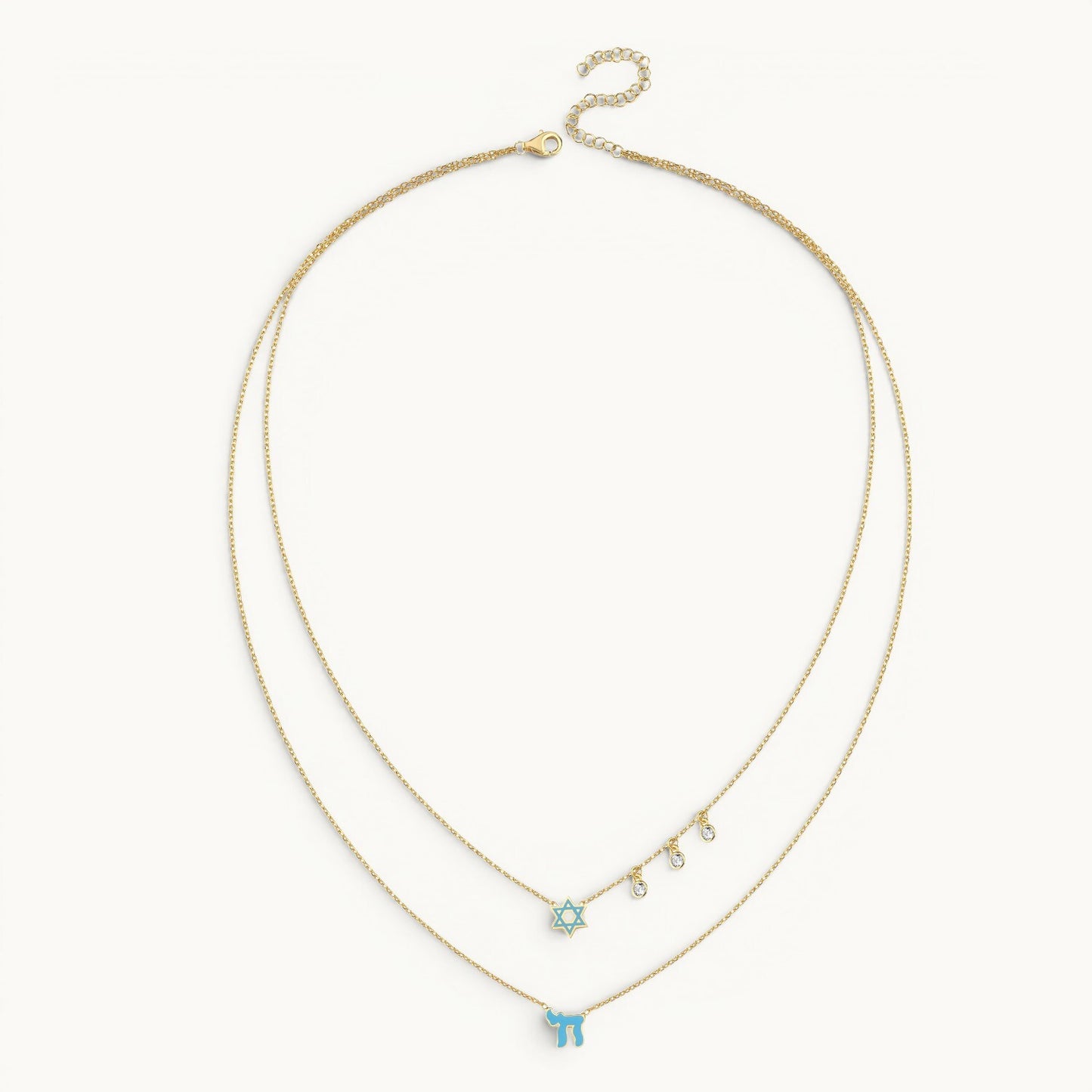 Layered necklace in gold with pink enamel Chai and Star of David charms by Alef Bet