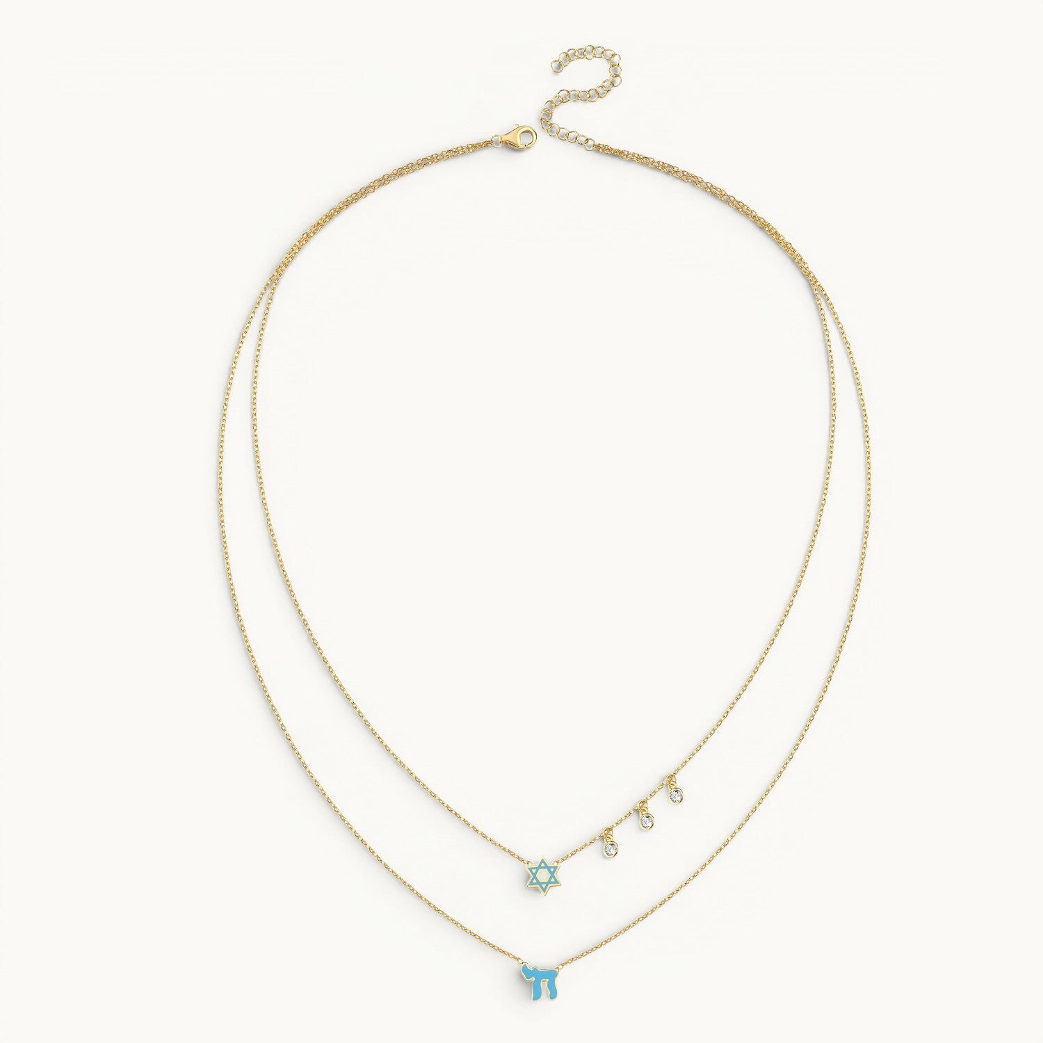 Layered necklace in gold with pink enamel Chai and Star of David charms by Alef Bet