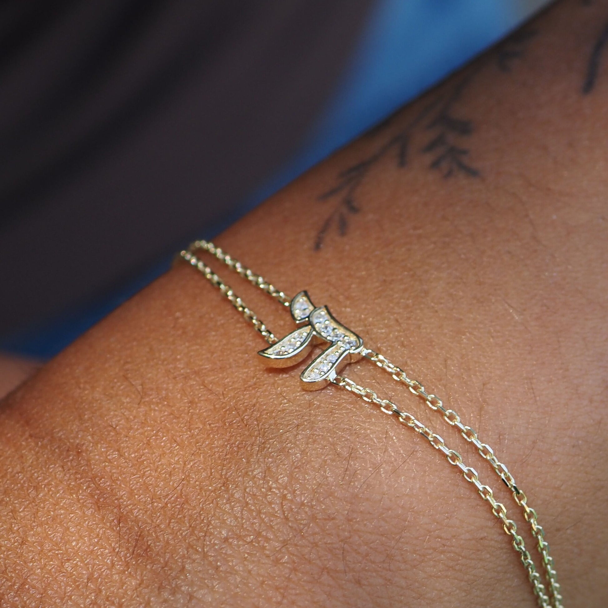 14k gold chai bracelet featuring dual chains with pave diamond accents by Alef Bet
