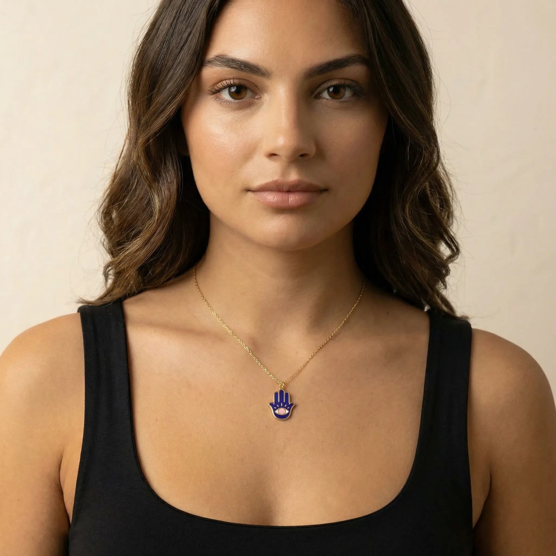 Bold gold plated hamsa pendant necklace featuring navy enamel and pink evil eye design by Alef Bet