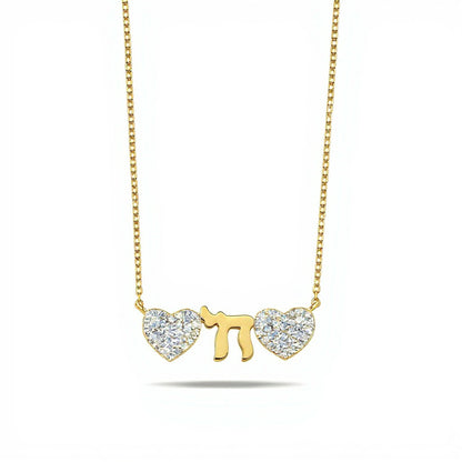 A person sitting at a desk, using a laptop, surrounded by books and papers, focused on work with coffee cup nearby.