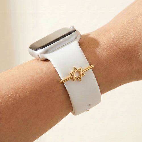 Smartwatch with a white band and Jewish star on a wrist against a beige background