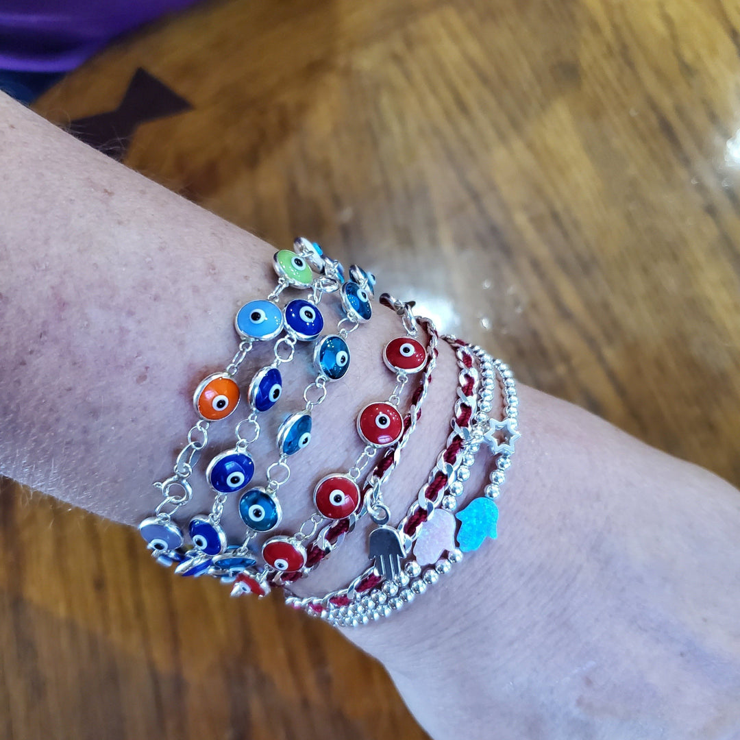 red string bracelet with hamsa